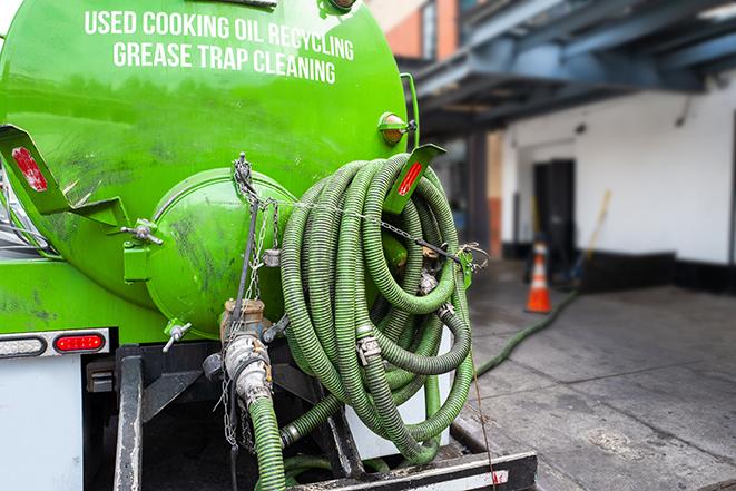 a grease trap pumping truck at a restaurant in Gadsden